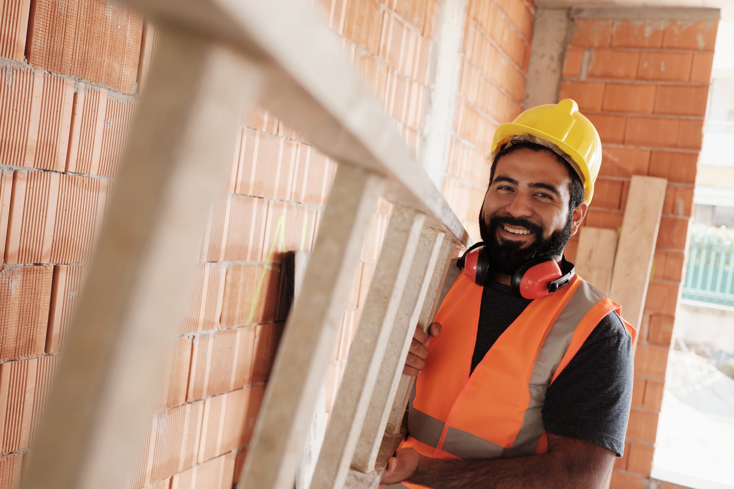 Portrait Of Happy Hispanic Worker Smiling In Construction Site
