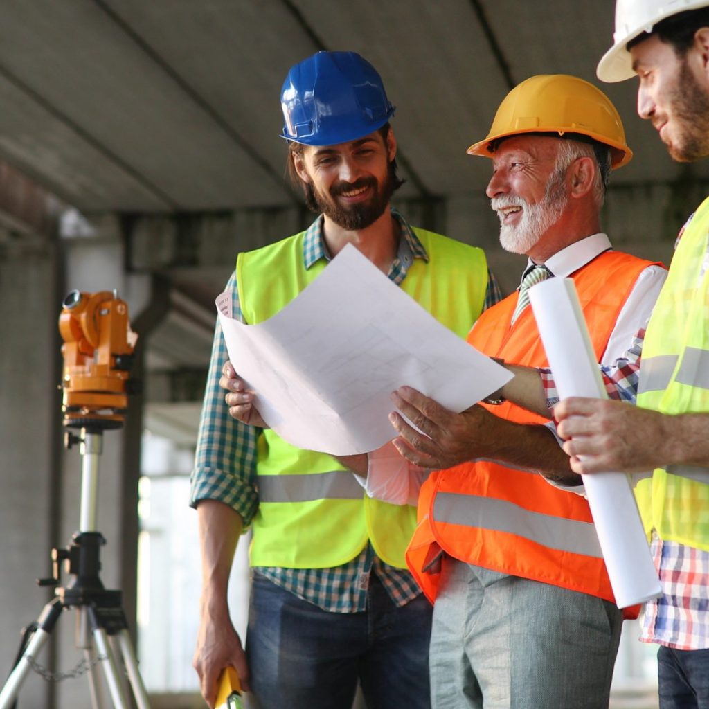 Team of construction engineers, architects working on building site